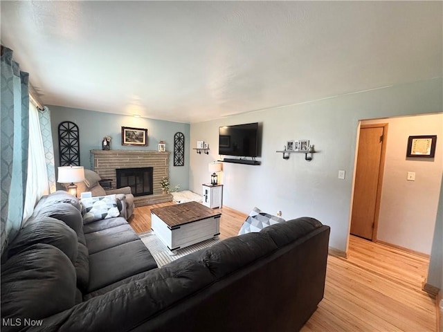 470 Geneva Ave, Struthers, OH 44471 - living room with light wood finished floors and a brick fireplace