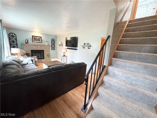 470 Geneva Ave, Struthers, OH 44471 - living area featuring hardwood / wood-style flooring, stairs, and a fireplace
