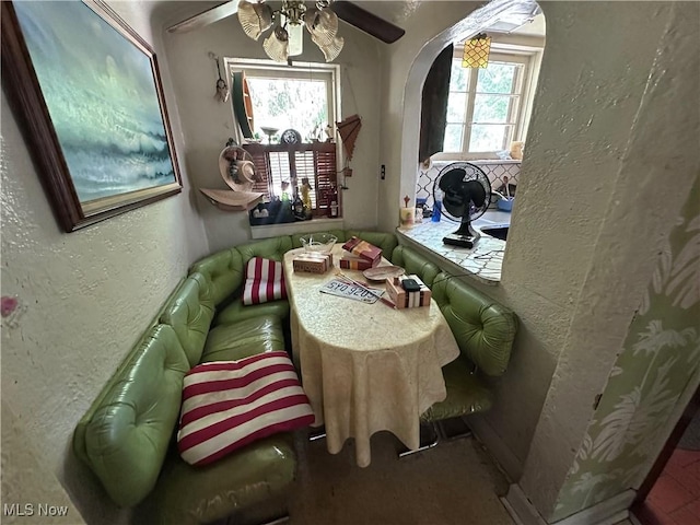 7742 Dahlia Dr, Mentor On The Lake, OH 44060 - dining space with arched walkways, a textured wall, and ceiling fan