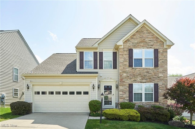 933 Alder Run Way, Akron, OH 44333 - traditional home with stone siding, concrete driveway, a shingled roof, and a garage