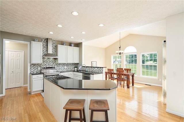 933 Alder Run Way, Akron, OH 44333 - kitchen with wall chimney exhaust hood, stainless steel appliances, light wood-style flooring, a chandelier, and recessed lighting