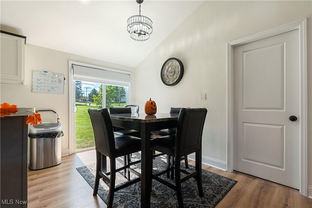 3316 Wadsworth Rd, Norton, OH 44203 - dining space featuring lofted ceiling, light wood-style floors, and a chandelier