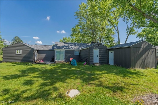 3316 Wadsworth Rd, Norton, OH 44203 - back of house with entry steps, a yard, and an outdoor structure