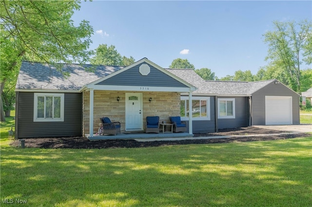 3316 Wadsworth Rd, Norton, OH 44203 - view of front of home with a front lawn, a porch, stone siding, and a garage
