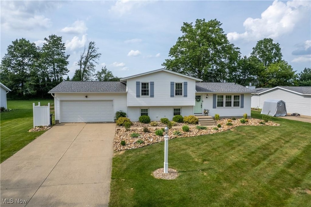 1114 Foxmoor Ln, Ashland, OH 44805 - split level home featuring a garage, driveway, and a front lawn