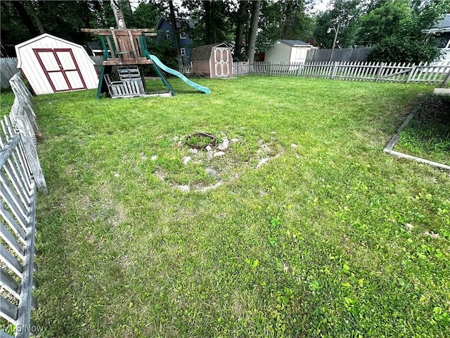 3886 Ascot Ct, Austintown, OH 44511 - fenced backyard featuring a storage shed and a playground