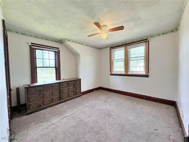 1307 W Ave, Elyria, OH 44035 - unfurnished room featuring a textured ceiling, a ceiling fan, plenty of natural light, and carpet
