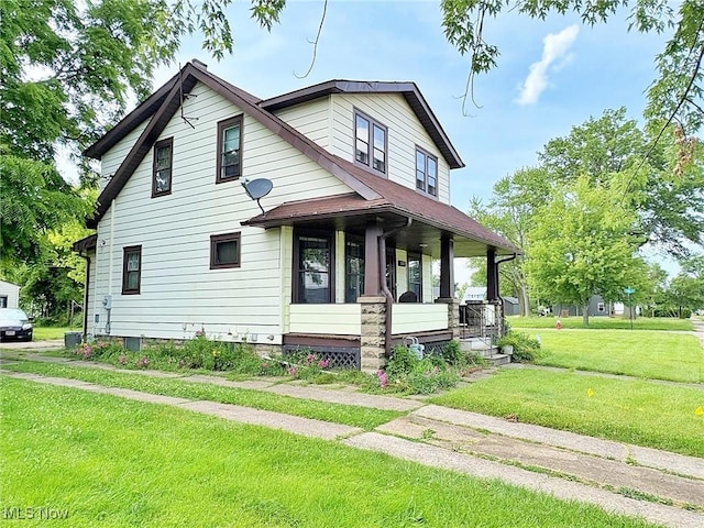 1307 W Ave, Elyria, OH 44035 - view of front facade with covered porch and a front lawn