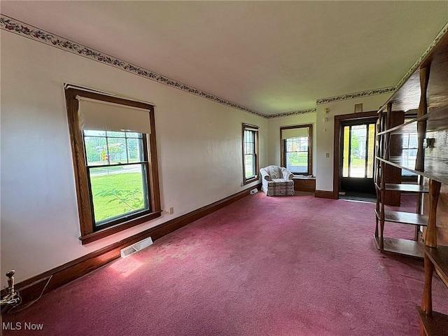 1307 W Ave, Elyria, OH 44035 - spare room featuring baseboards and dark carpet