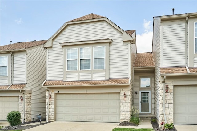 1435 Durham Dr, Broadview Heights, OH 44147 - townhome / multi-family property with stone siding, a garage, concrete driveway, and roof with shingles