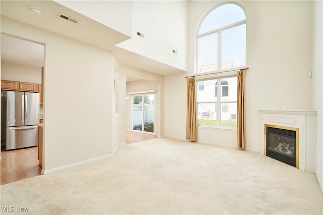 1435 Durham Dr, Broadview Heights, OH 44147 - unfurnished living room with light colored carpet, a glass covered fireplace, and a high ceiling