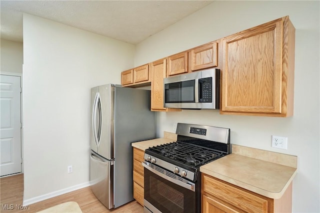 1435 Durham Dr, Broadview Heights, OH 44147 - kitchen with appliances with stainless steel finishes, light wood-style flooring, light countertops, and light brown cabinetry