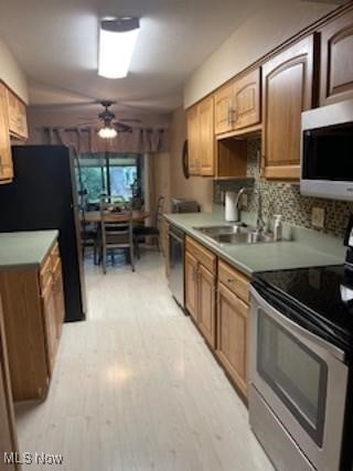 82 Silver Valley Blvd, Munroe Falls, OH 44262 - kitchen with stainless steel appliances, ceiling fan, light wood-style floors, backsplash, and light countertops