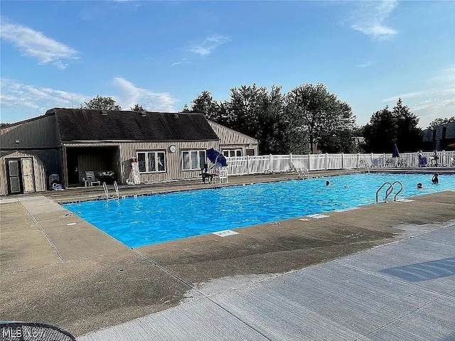 9630 Cove Dr Unit A14, North Royalton, OH 44133 - community pool with a patio and a storage shed