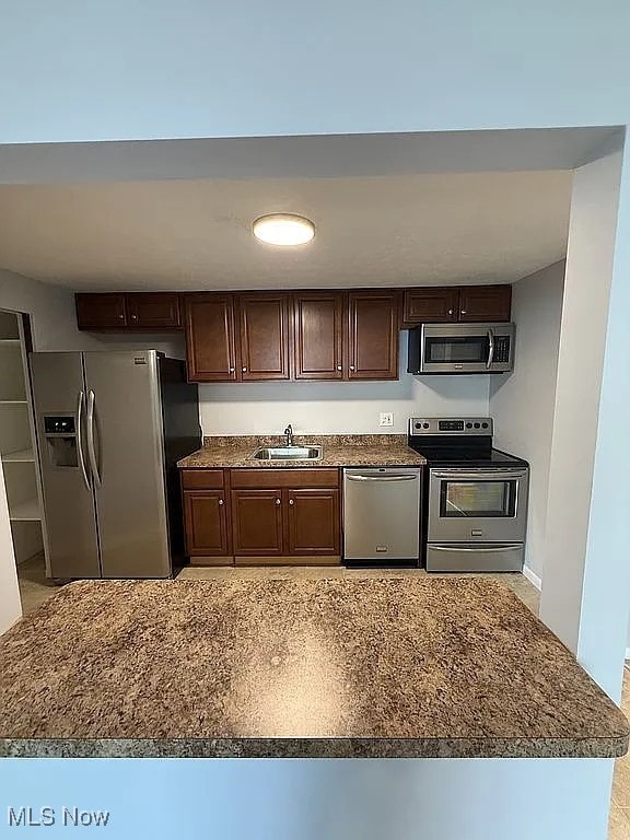 9630 Cove Dr Unit A14, North Royalton, OH 44133 - kitchen featuring stainless steel appliances and dark brown cabinets