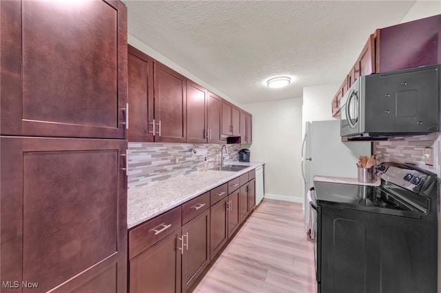 2910 N Bay Dr Unit L11, Westlake, OH 44145 - kitchen with black / electric stove, backsplash, a textured ceiling, light wood finished floors, and light stone countertops