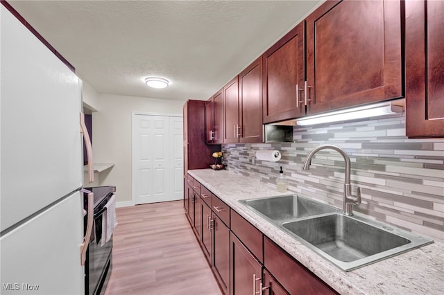 2910 N Bay Dr Unit L11, Westlake, OH 44145 - kitchen with freestanding refrigerator, black / electric stove, decorative backsplash, a textured ceiling, and light countertops