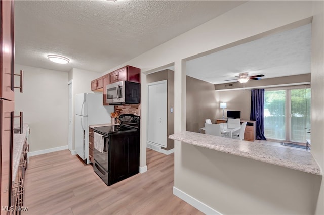 2910 N Bay Dr Unit L11, Westlake, OH 44145 - kitchen featuring electric range, stainless steel microwave, light wood-style floors, a textured ceiling, and a desk