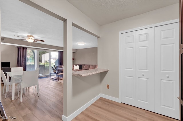 2910 N Bay Dr Unit L11, Westlake, OH 44145 - kitchen featuring light wood-type flooring, a ceiling fan, a textured ceiling, light countertops, and open floor plan