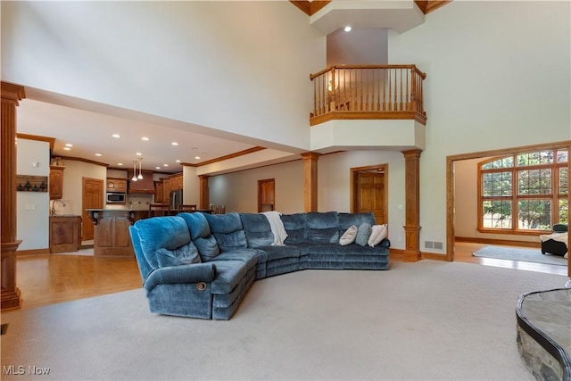 2840 Barclay Cir NW, North Canton, OH 44720 - living room with decorative columns, a towering ceiling, ornamental molding, light colored carpet, and recessed lighting