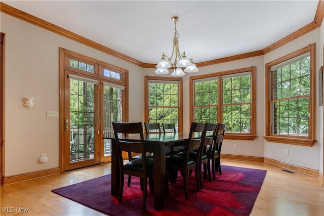 2840 Barclay Cir NW, North Canton, OH 44720 - dining space with a chandelier, plenty of natural light, wood finished floors, and ornamental molding