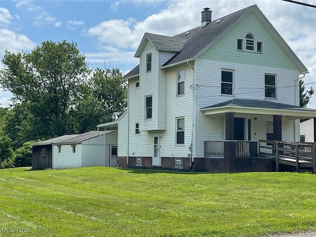 4034 Broadway Ave NE, Louisville, OH 44641 - rear view of house with a lawn, covered porch, a chimney, and roof with shingles