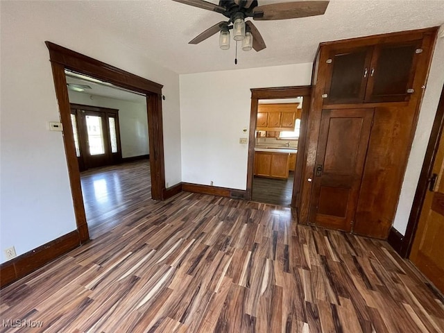 4034 Broadway Ave NE, Louisville, OH 44641 - unfurnished room featuring dark wood-style floors, ceiling fan, and a textured ceiling