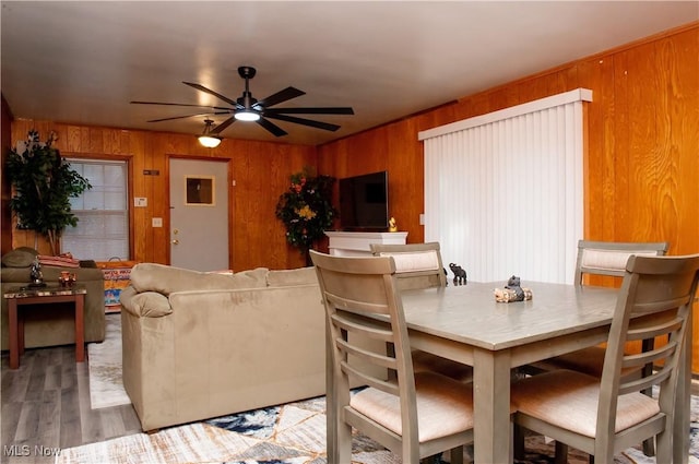 1863 Deerfield Ave SW, Warren, OH 44485 - dining room with wood walls, ceiling fan, and wood finished floors