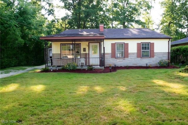 1863 Deerfield Ave SW, Warren, OH 44485 - single story home with a porch, stone siding, a front lawn, and a chimney