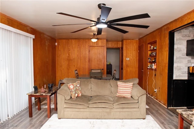 1863 Deerfield Ave SW, Warren, OH 44485 - living room featuring wooden walls, ceiling fan, and light wood finished floors