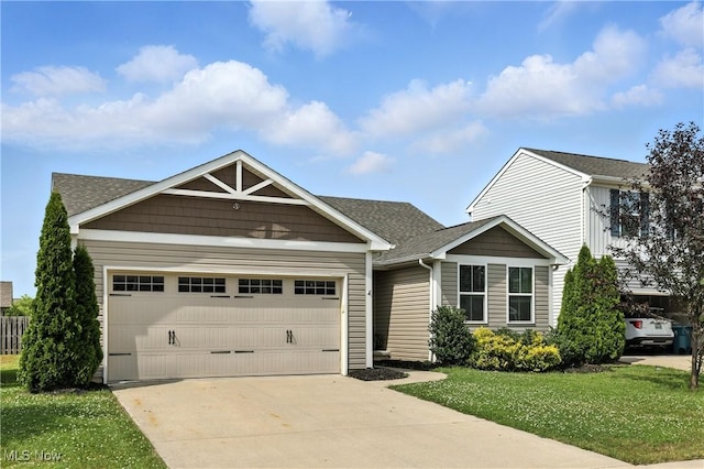107 Lakeview Cir, Amherst, OH 44001 - view of front of property featuring a garage, driveway, a front yard, and a shingled roof
