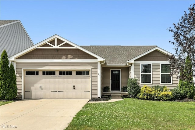 107 Lakeview Cir, Amherst, OH 44001 - view of front facade with an attached garage, driveway, a front lawn, and roof with shingles