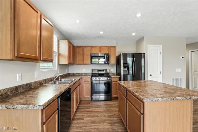 107 Lakeview Cir, Amherst, OH 44001 - kitchen featuring black appliances, dark wood-type flooring, a center island, recessed lighting, and dark countertops