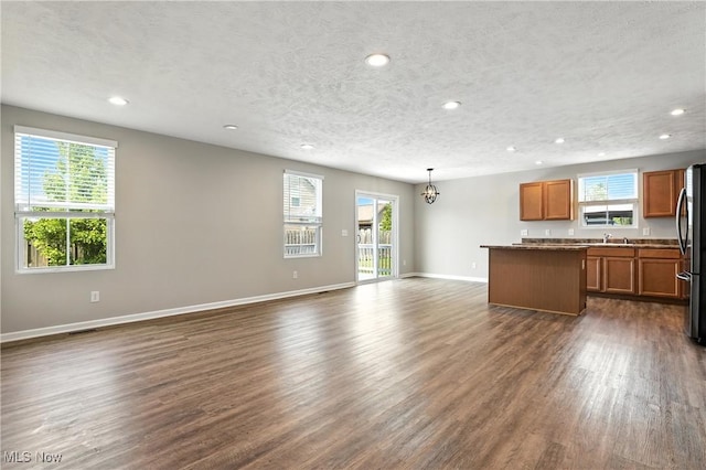 107 Lakeview Cir, Amherst, OH 44001 - unfurnished living room with recessed lighting, dark wood finished floors, plenty of natural light, a chandelier, and a textured ceiling