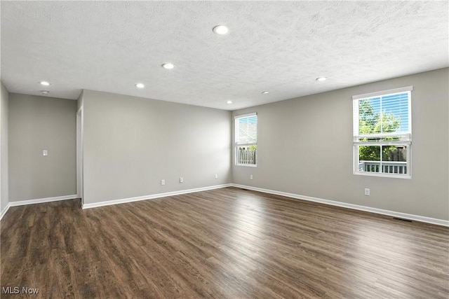 107 Lakeview Cir, Amherst, OH 44001 - unfurnished room featuring recessed lighting, dark wood-style flooring, plenty of natural light, and a textured ceiling