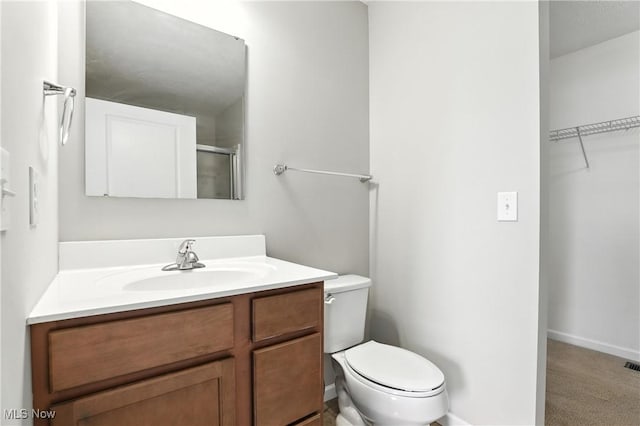 107 Lakeview Cir, Amherst, OH 44001 - bathroom featuring vanity, a spacious closet, and a shower with shower door