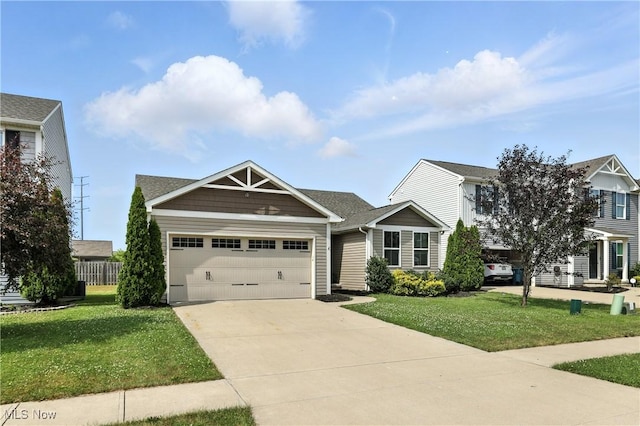 107 Lakeview Cir, Amherst, OH 44001 - view of front of home featuring a garage, driveway, and a front yard