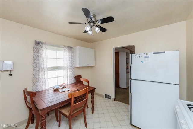4766 Brookwood Dr, Brooklyn, OH 44144 - dining room with light floors, ceiling fan, and arched walkways