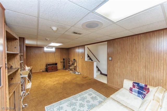 4766 Brookwood Dr, Brooklyn, OH 44144 - carpeted living room featuring wood walls, stairway, and a paneled ceiling
