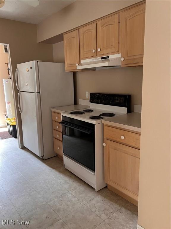 19510 Lorain Rd Unit 201, Fairview Park, OH 44126 - kitchen with white appliances, light brown cabinetry, under cabinet range hood, light countertops, and water heater