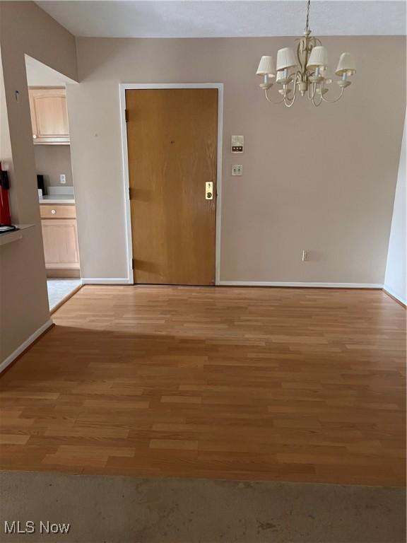 19510 Lorain Rd Unit 201, Fairview Park, OH 44126 - unfurnished dining area featuring a chandelier and light wood-style flooring
