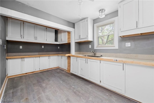 2922 Cory Ave, Akron, OH 44314 - kitchen featuring wood finished floors, light countertops, and white cabinets