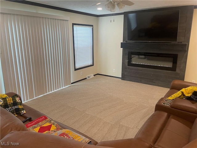 83478 Monzula Rd, Cadiz, OH 43907 - living room with carpet, a ceiling fan, crown molding, and a glass covered fireplace
