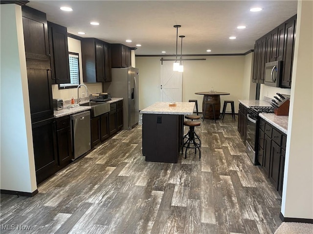 83478 Monzula Rd, Cadiz, OH 43907 - kitchen with stainless steel appliances, a center island, a kitchen bar, dark wood finished floors, and recessed lighting