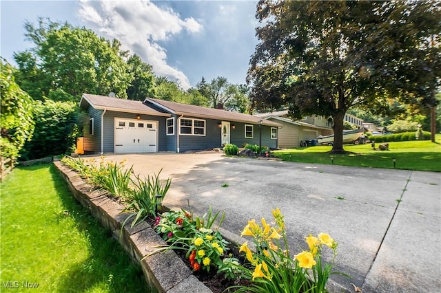 216 W Glenridge Rd, Green, OH 44319 - ranch-style house featuring a garage, concrete driveway, and a front yard