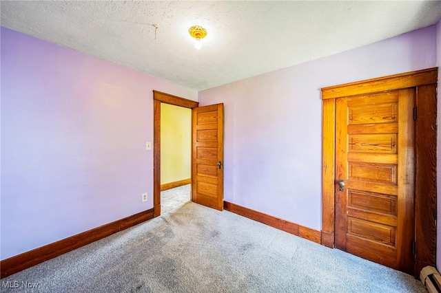 13778 Spring St, Burton, OH 44021 - carpeted empty room with baseboards and a textured ceiling