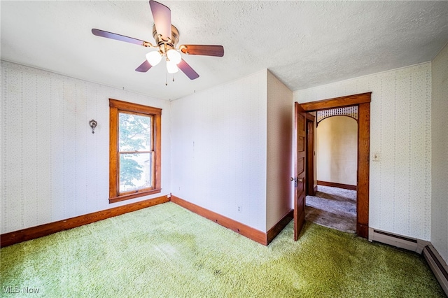 13778 Spring St, Burton, OH 44021 - carpeted empty room featuring a baseboard radiator and a ceiling fan