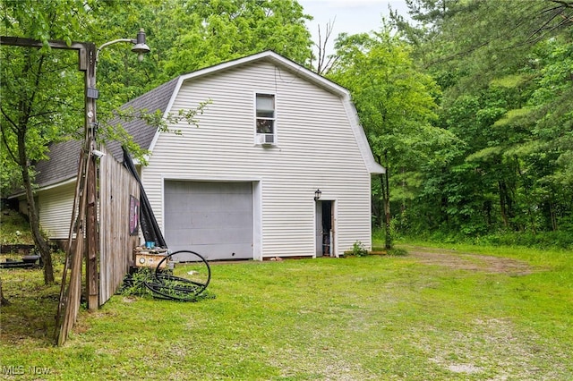 8902 Taylor May Rd, Chagrin Falls, OH 44023 - view of side of home featuring a gambrel roof, a lawn, a shingled roof, and a garage