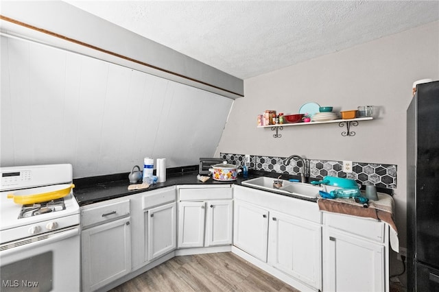 8902 Taylor May Rd, Chagrin Falls, OH 44023 - kitchen with white range with gas stovetop, a textured ceiling, light wood-style flooring, dark countertops, and open shelves