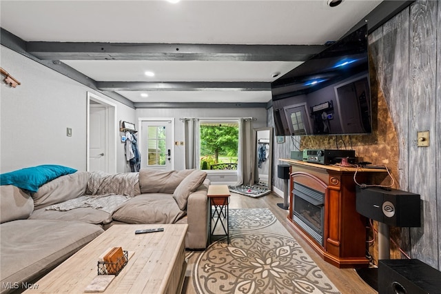 8902 Taylor May Rd, Chagrin Falls, OH 44023 - living room featuring light wood finished floors, a glass covered fireplace, and beamed ceiling